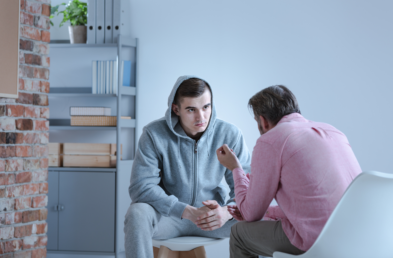 Man talking to counselor regarding his addiction problems and seeking help