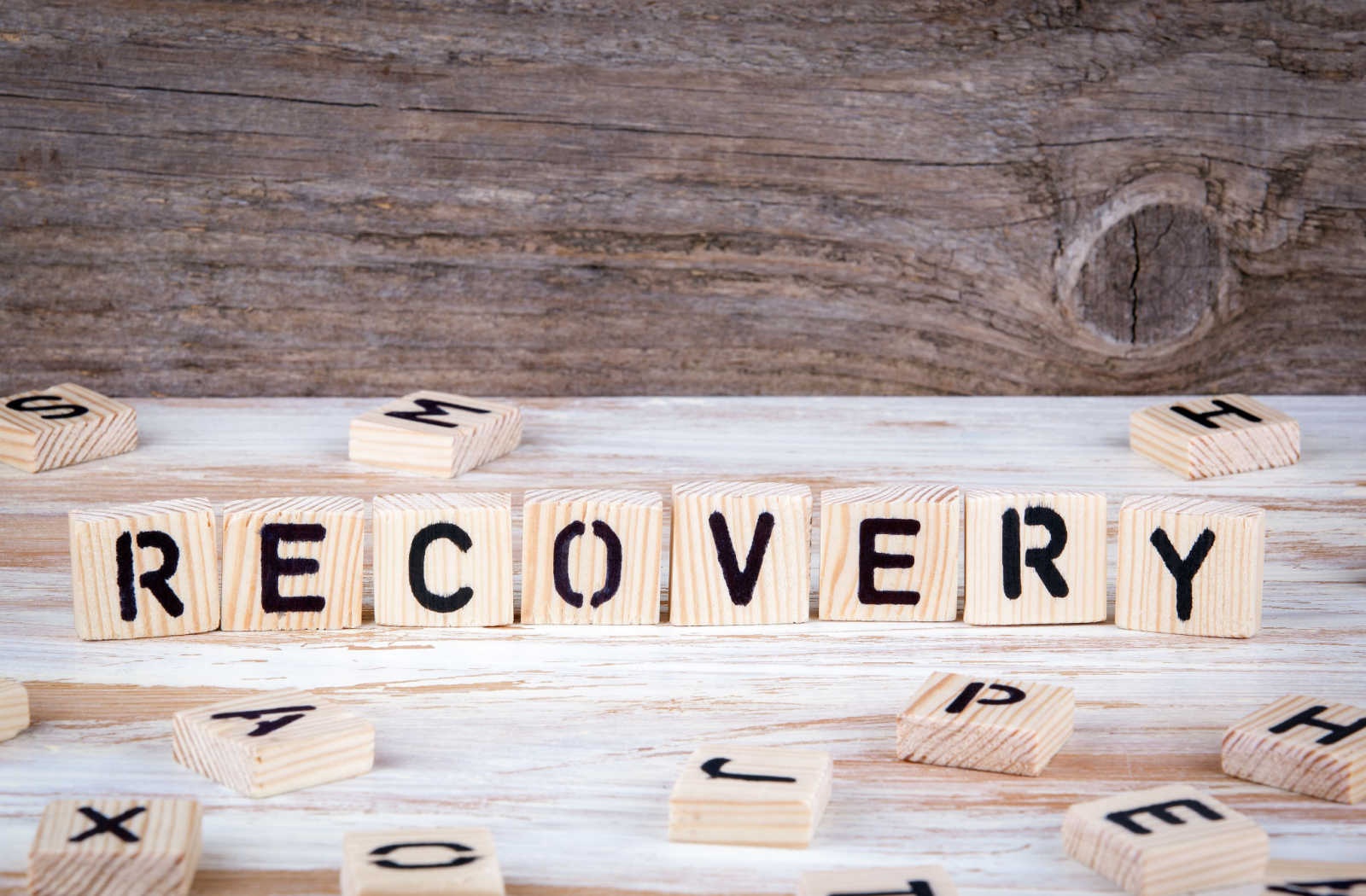 The word recovery written in wood letter blocks