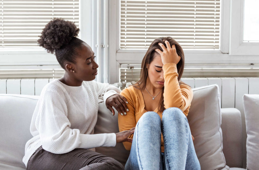 A girl having a one-on-one conversation with her friend to comfort her and help her overcome her trouble with addiction.