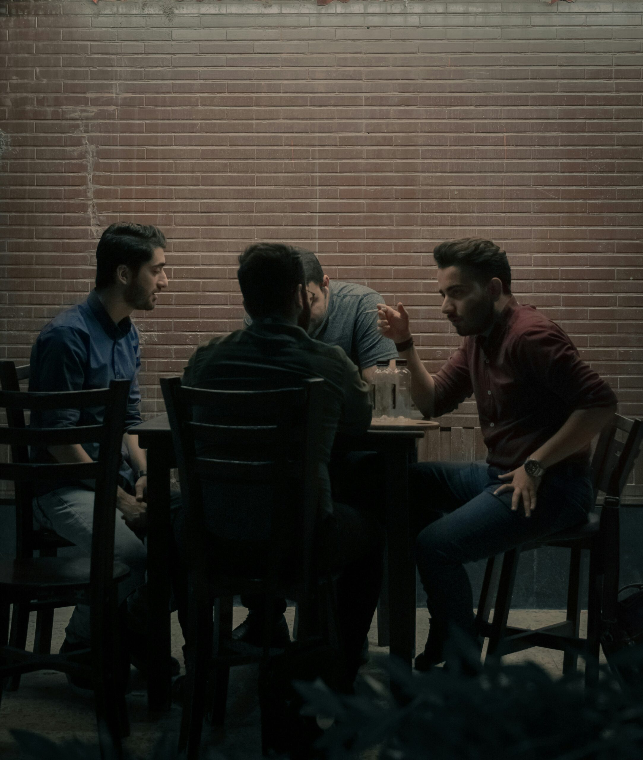 Group of people talking at a table sitting down