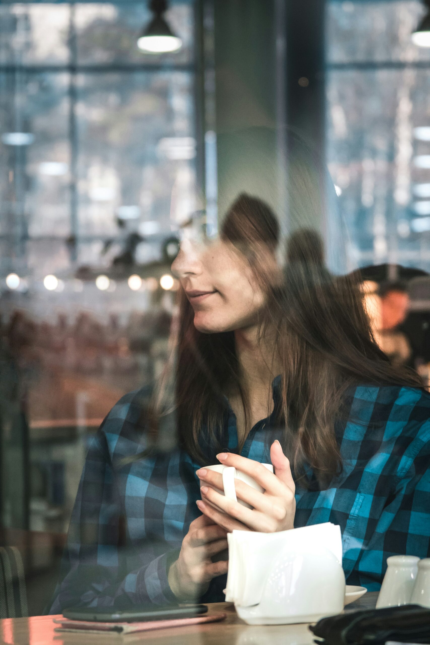 person looking out cafe window