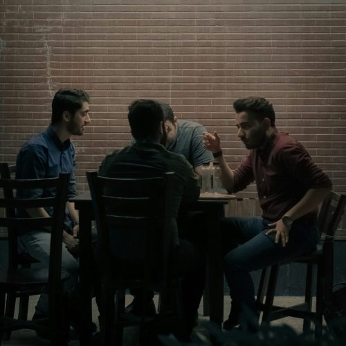 Group of people talking at a table sitting down